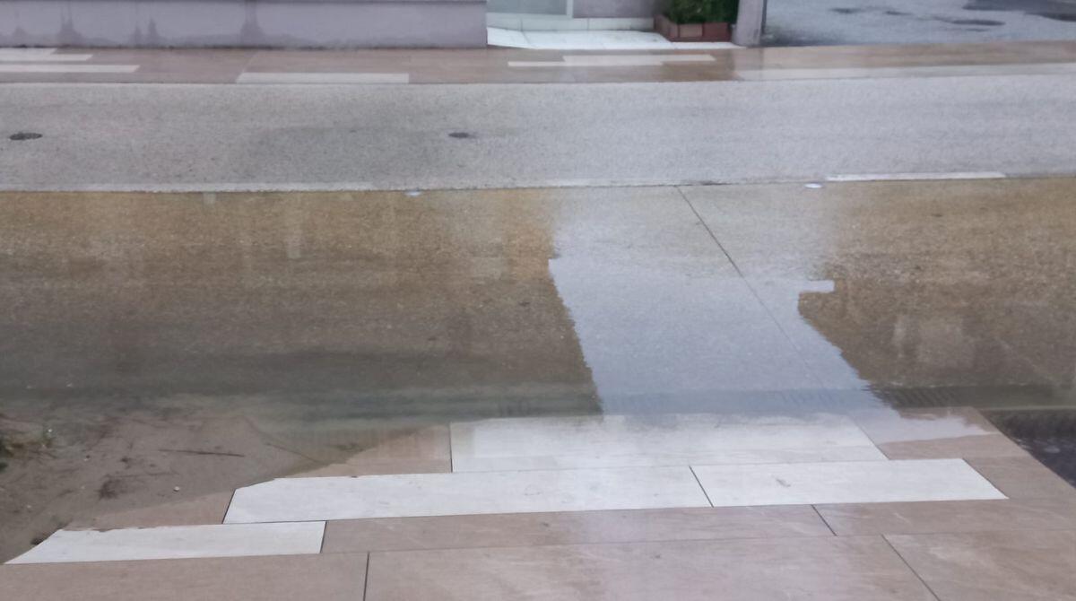 Rimini Nord, pioggia e caditoie allagate. Benaglia ironizza: “pulirle prima dell’inverno è cosa quasi banale” - Una parte di strada allagata