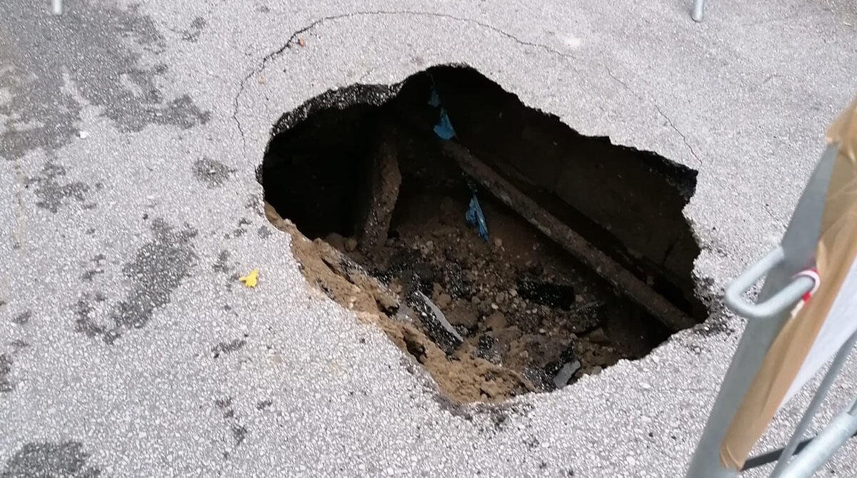 Cede l'asfalto in pieno centro storico e si apre una voragine: strada chiusa a Verucchio - Le immagini della voragine